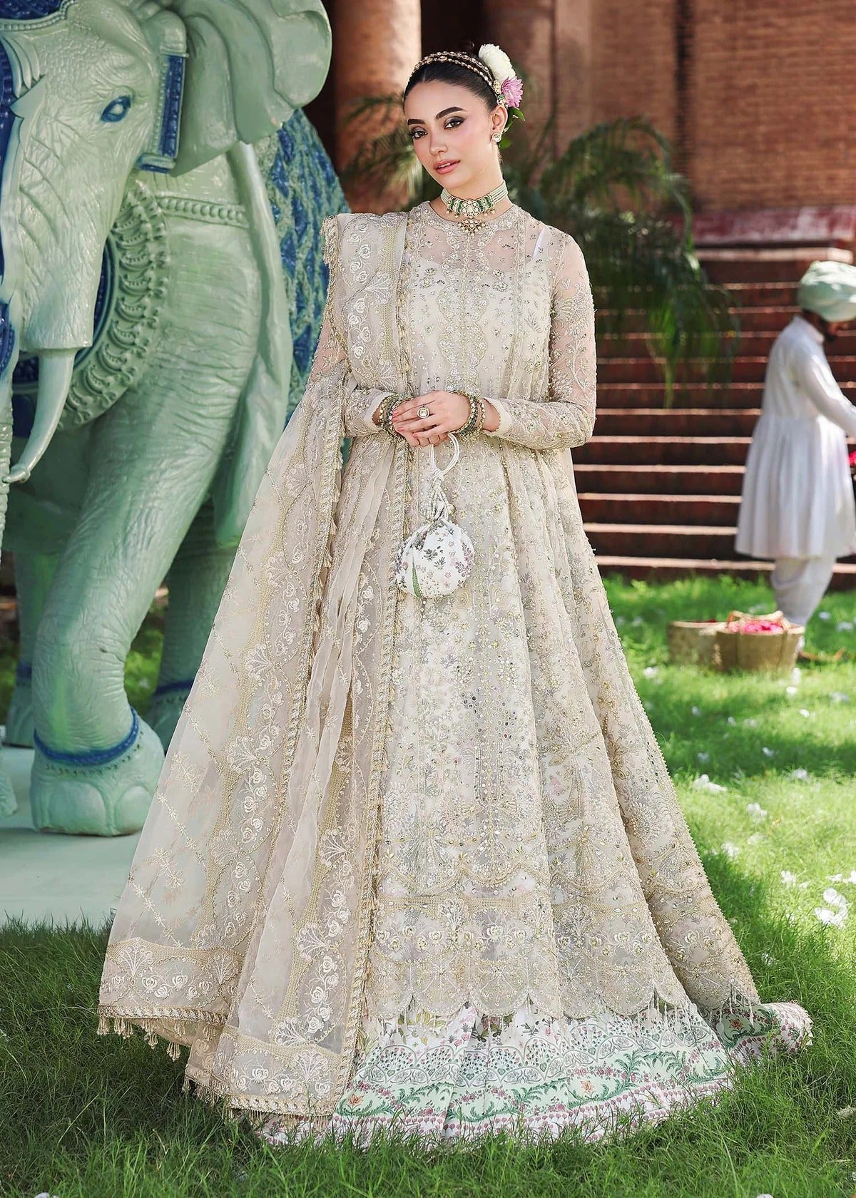 Elevate your look with this dusty white organza outfit featuring intricate hand embroidery, printed raw silk trouser, and elegant embroidered dupatta.