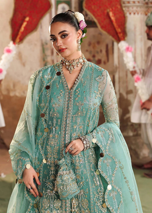 Discover timeless elegance with this turquoise organza outfit featuring intricate hand embroidery, foil-printed raw silk trouser, and embroidered dupatta.