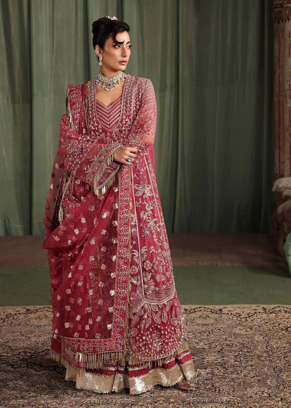 Step into elegance with this carrot pink organza ensemble featuring intricate hand embroidery, pure zari dupatta, and raw silk trouser for a refined look.