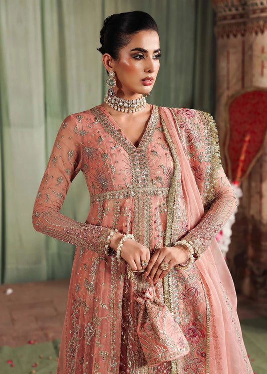 Radiate elegance in this peach organza outfit featuring intricate hand embroidery, foil printed raw silk trouser, and a beautifully embroidered dupatta.