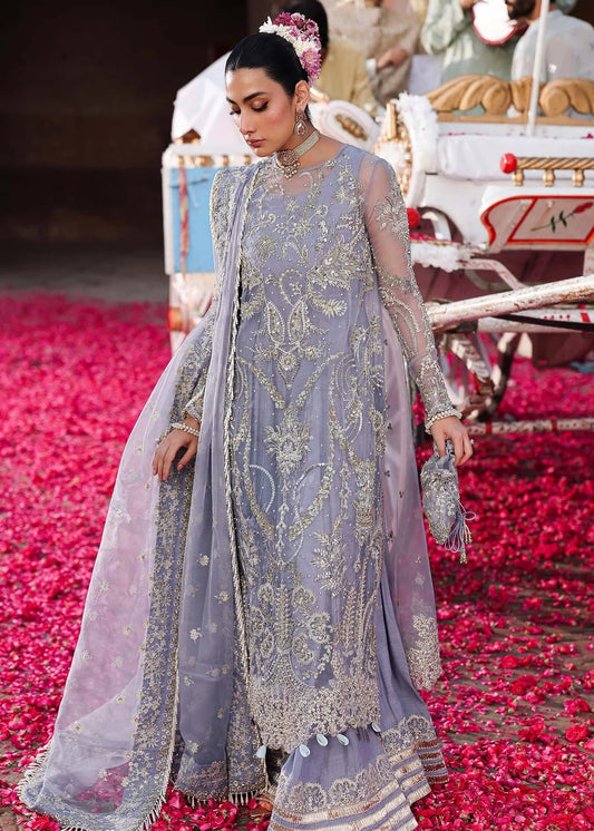 Grace your occasions with this periwinkle organza ensemble featuring hand-embroidered panels, borders, and dupatta, paired with a raw silk trouser for elegance.