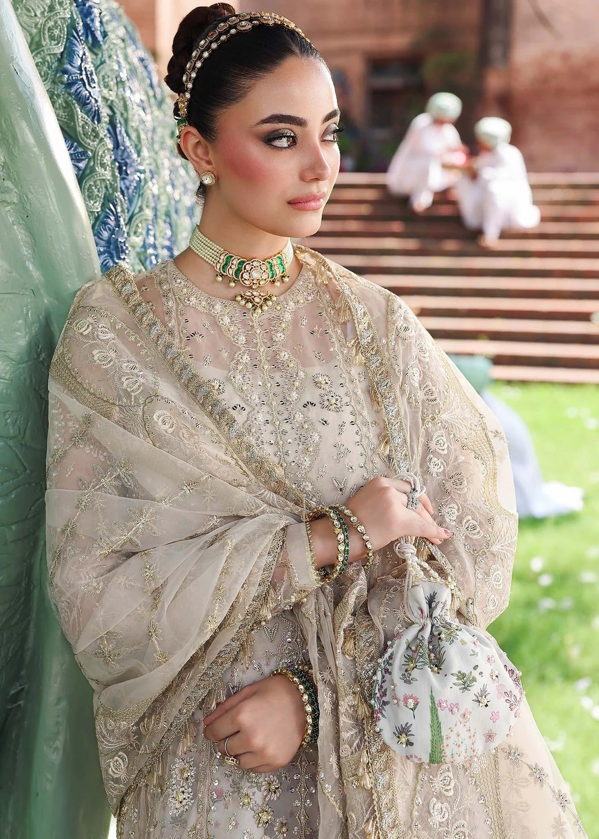 Elevate your look with this dusty white organza outfit featuring intricate hand embroidery, printed raw silk trouser, and elegant embroidered dupatta.