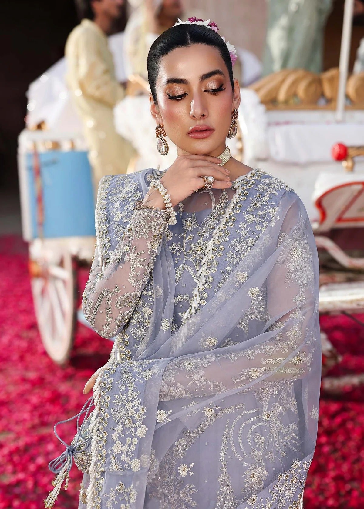 Grace your occasions with this periwinkle organza ensemble featuring hand-embroidered panels, borders, and dupatta, paired with a raw silk trouser for elegance.
