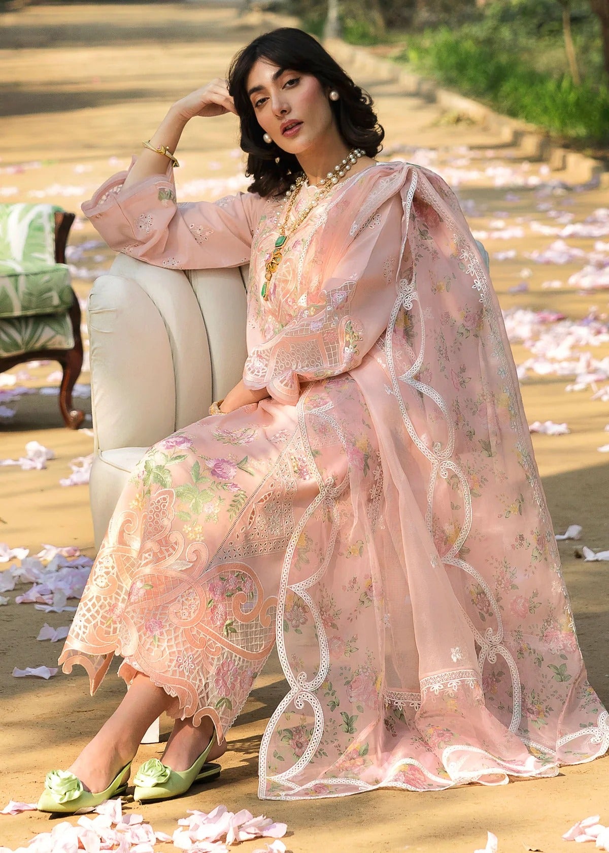 Grace your look with this peach embroidered lawn suit featuring chikan-kari panels, hand-work neckline, net dupatta, and cotton trouser.