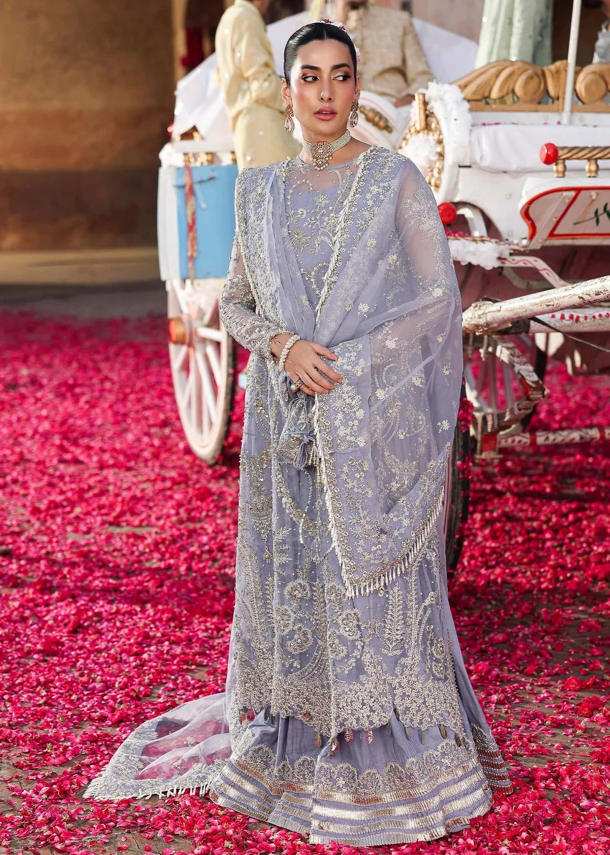 Grace your occasions with this periwinkle organza ensemble featuring hand-embroidered panels, borders, and dupatta, paired with a raw silk trouser for elegance.
