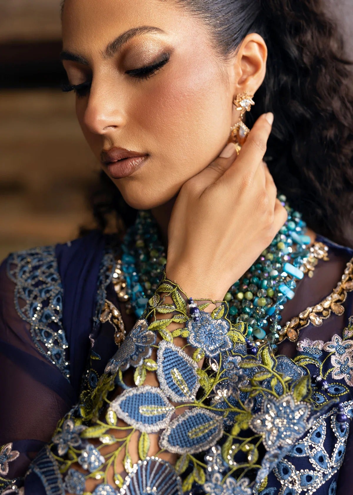Stunning chiffon embroidered suit with hand-embellished neckline, cutwork motifs, diamante dupatta, and printed raw silk trouser for festive elegance.