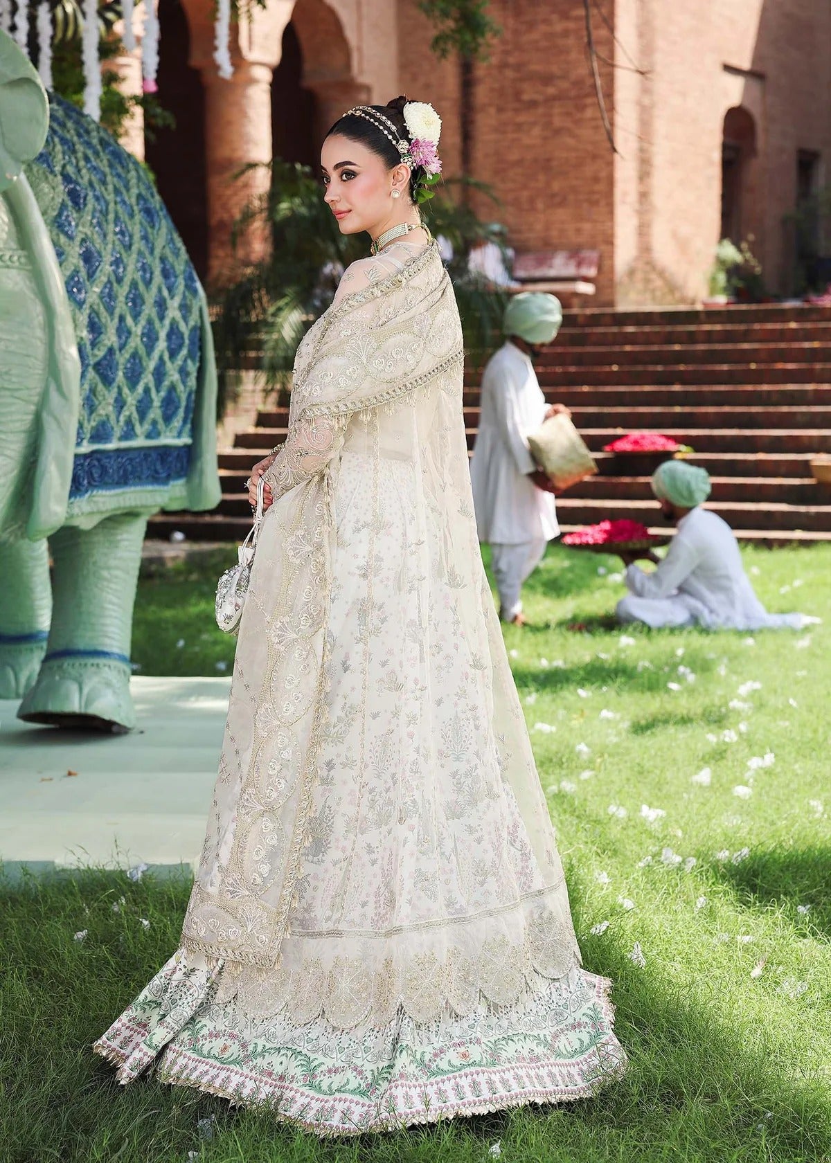 Elevate your look with this dusty white organza outfit featuring intricate hand embroidery, printed raw silk trouser, and elegant embroidered dupatta.