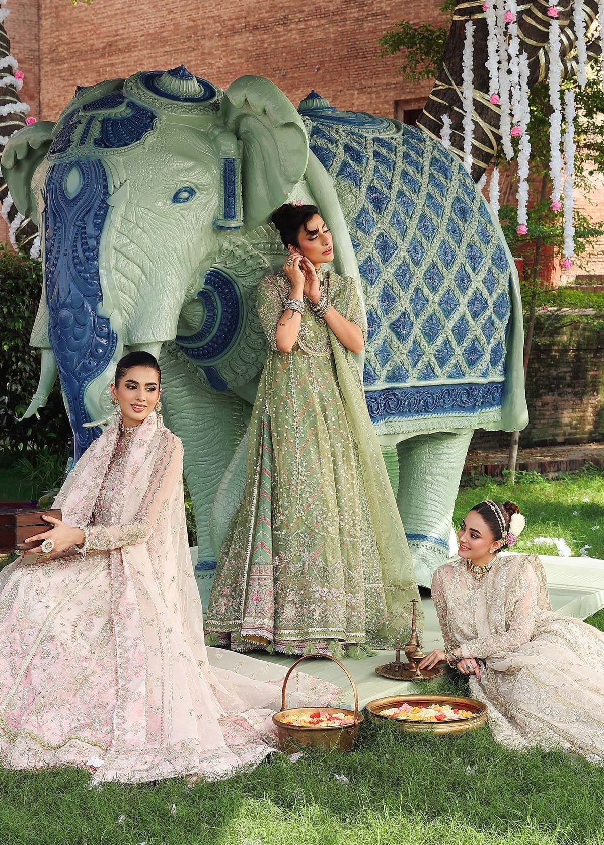 Elevate your festive look with this sage green zari organza outfit featuring delicate hand embroidery, printed raw silk trousers, and an elegant dupatta.