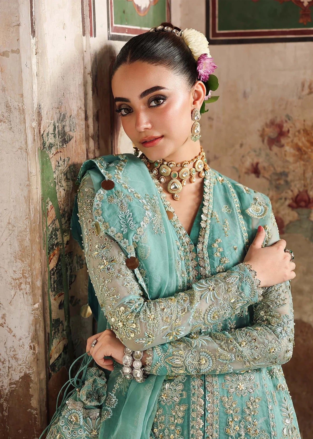 Discover timeless elegance with this turquoise organza outfit featuring intricate hand embroidery, foil-printed raw silk trouser, and embroidered dupatta.
