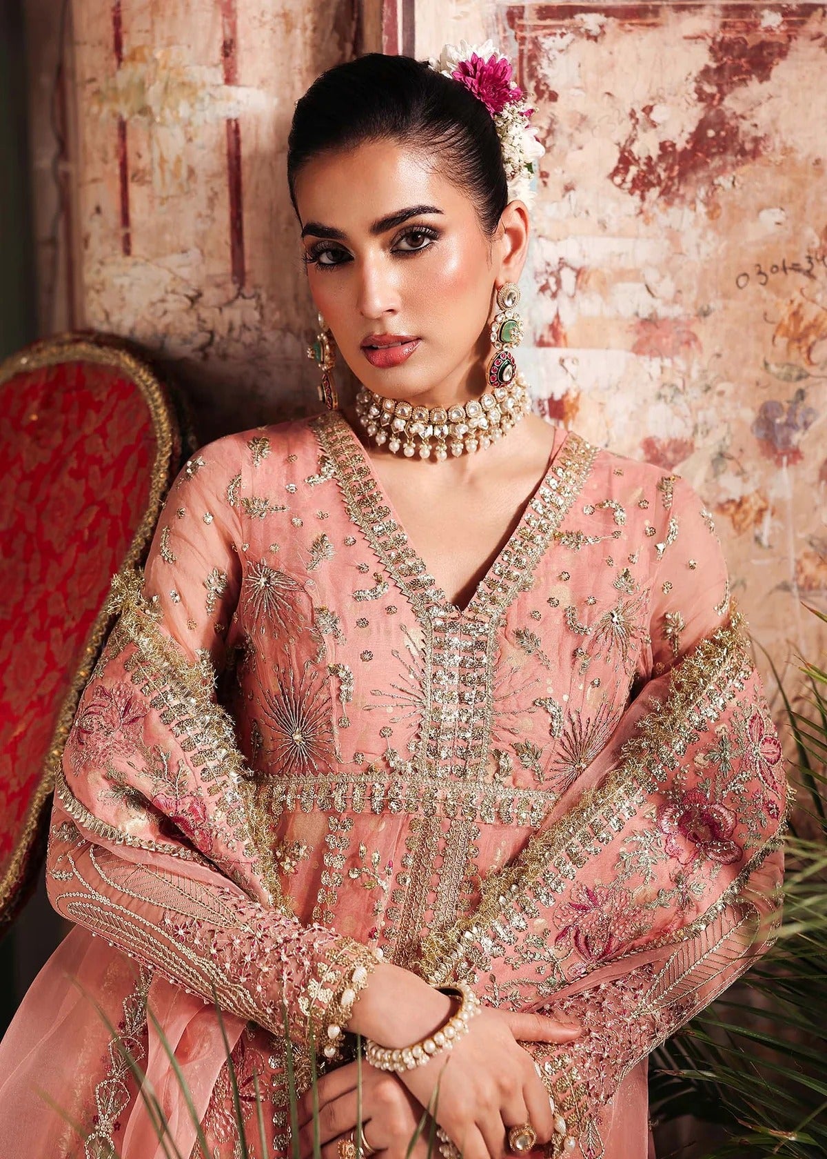 Radiate elegance in this peach organza outfit featuring intricate hand embroidery, foil printed raw silk trouser, and a beautifully embroidered dupatta.