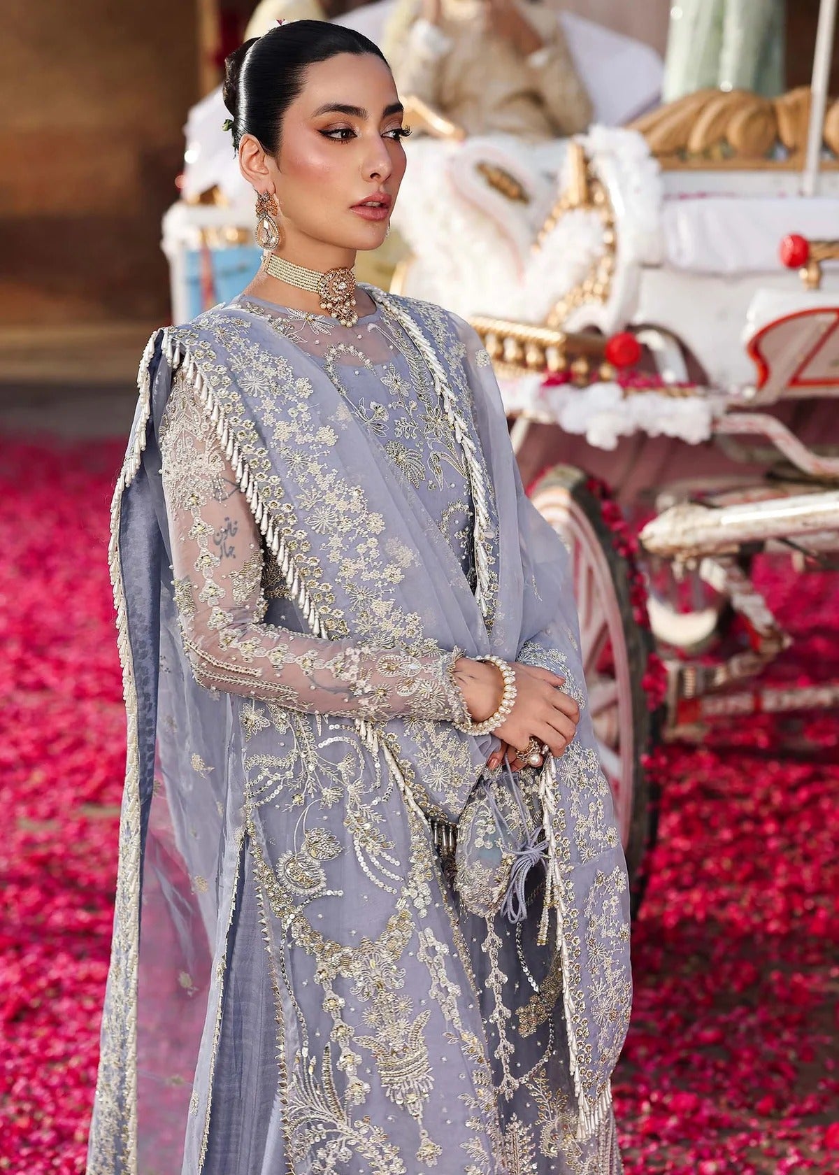 Grace your occasions with this periwinkle organza ensemble featuring hand-embroidered panels, borders, and dupatta, paired with a raw silk trouser for elegance.