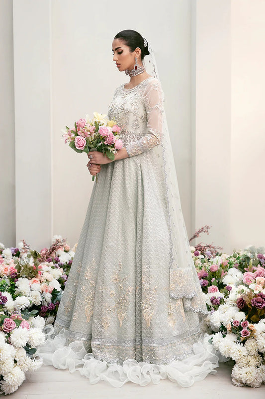 Elegant organza embroidered suit with hand-embellished bodice, cutwork panels, detailed borders, dupatta, and premium raw silk trouser fabric.