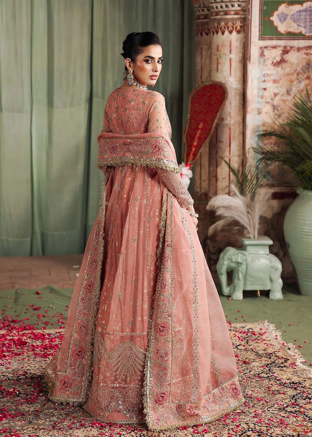 Radiate elegance in this peach organza outfit featuring intricate hand embroidery, foil printed raw silk trouser, and a beautifully embroidered dupatta.