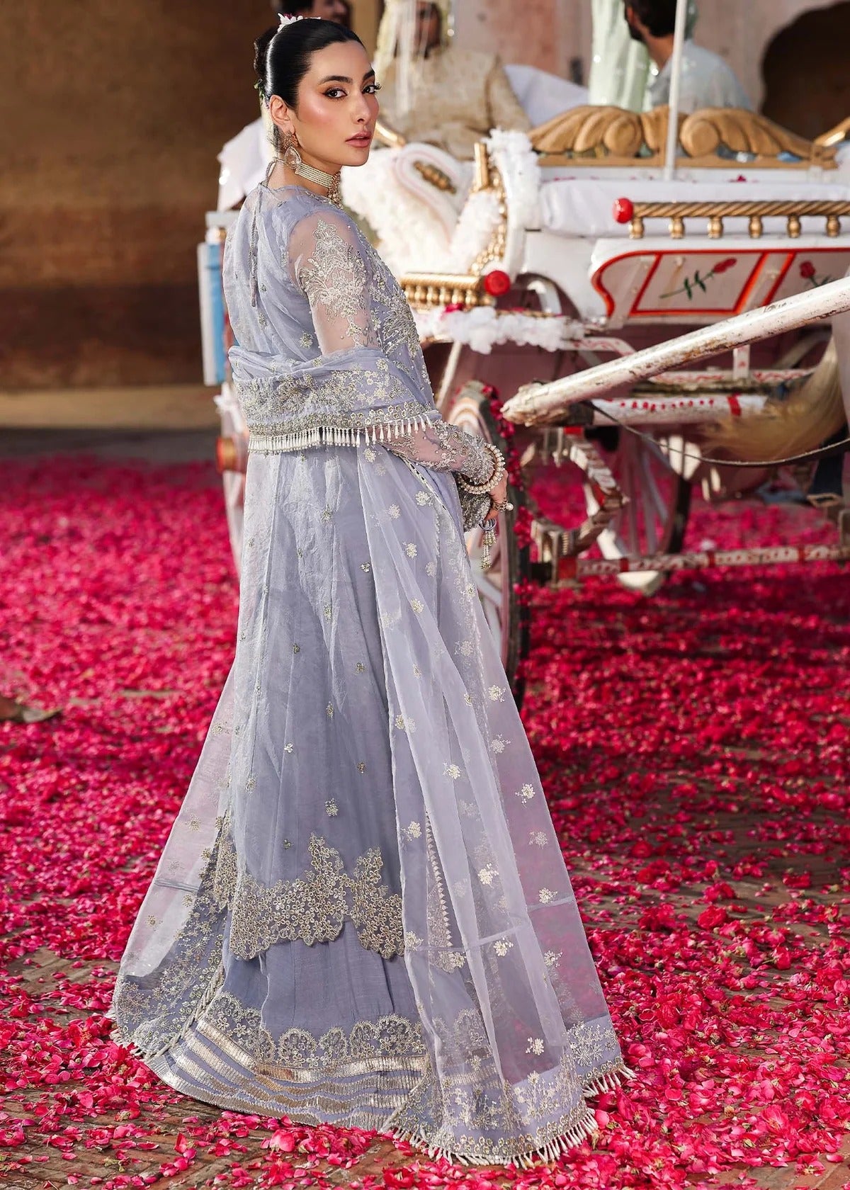 Grace your occasions with this periwinkle organza ensemble featuring hand-embroidered panels, borders, and dupatta, paired with a raw silk trouser for elegance.