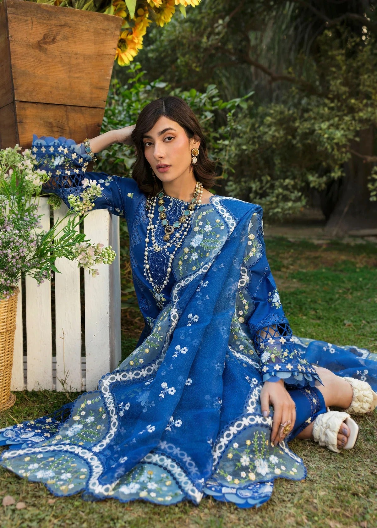 Step into elegance with this blue embroidered lawn suit featuring chikan-kari panels, hand-work neckline, net dupatta, and cotton trouser.