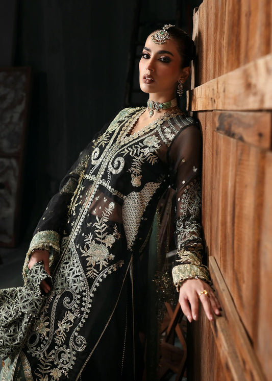 Elegant black organza dress with embroidered cutwork panels, dupatta & raw silk trouser. Available stitched or unstitched with custom sizing options.
