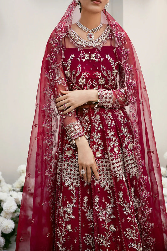 Graceful organza and poly net embroidered suit featuring hand-embellished bodice, cutwork panels, organza borders, dupatta, and raw silk trouser fabric.