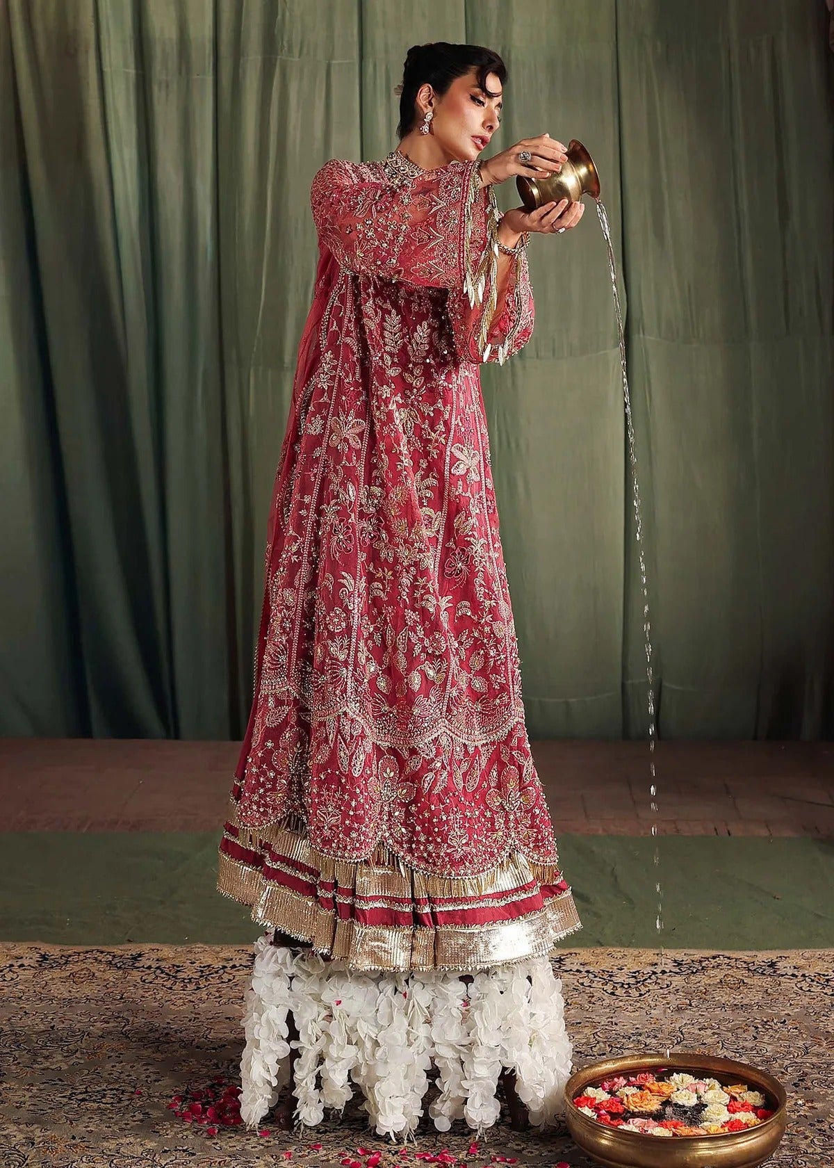 Step into elegance with this carrot pink organza ensemble featuring intricate hand embroidery, pure zari dupatta, and raw silk trouser for a refined look.