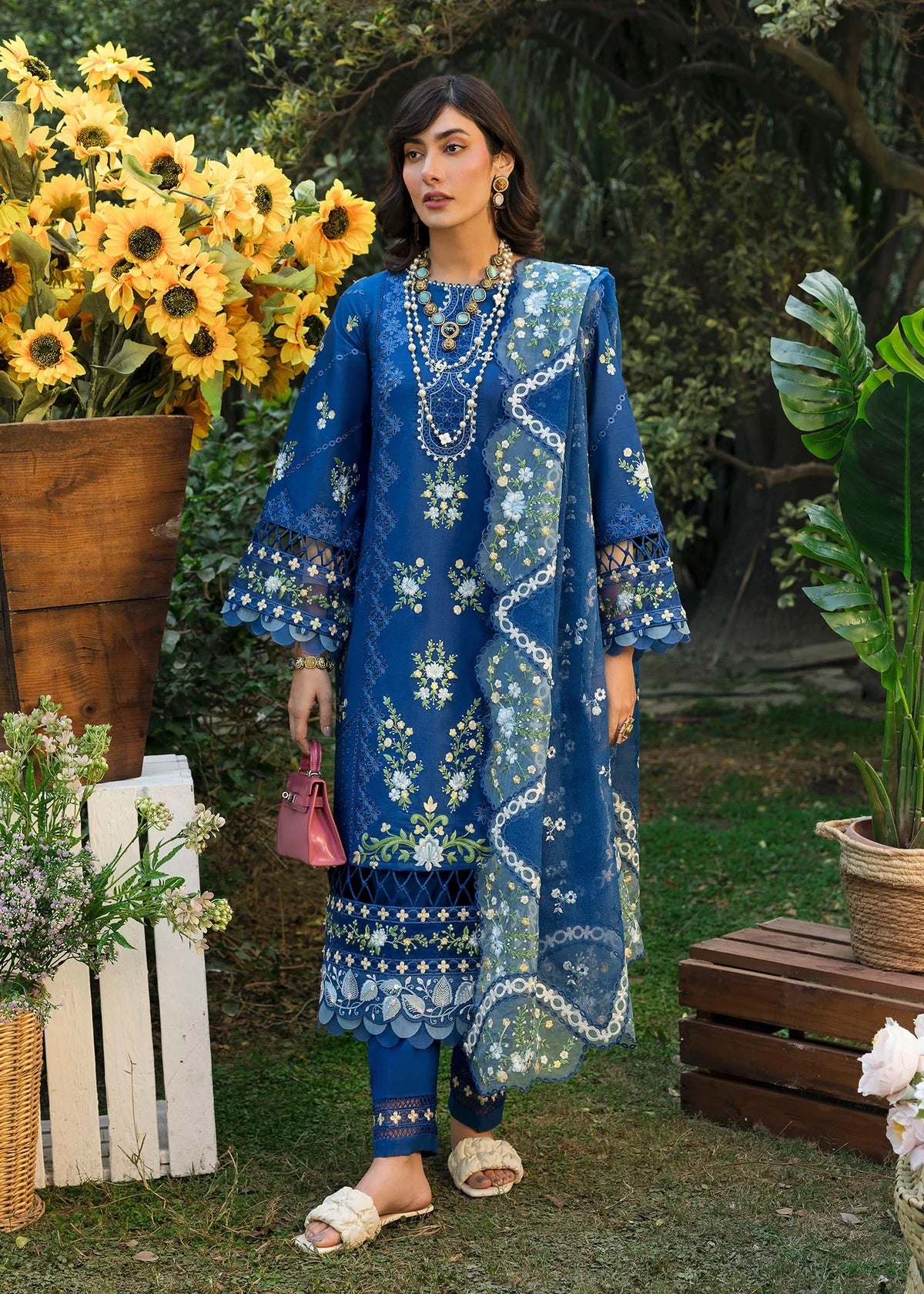 Step into elegance with this blue embroidered lawn suit featuring chikan-kari panels, hand-work neckline, net dupatta, and cotton trouser.