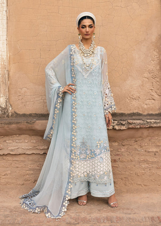 Luxury chiffon suit with hand-embellished neckline, 3D floral sleeve motifs, cutwork borders, diamante dupatta, and raw silk trouser — perfect for occasions.