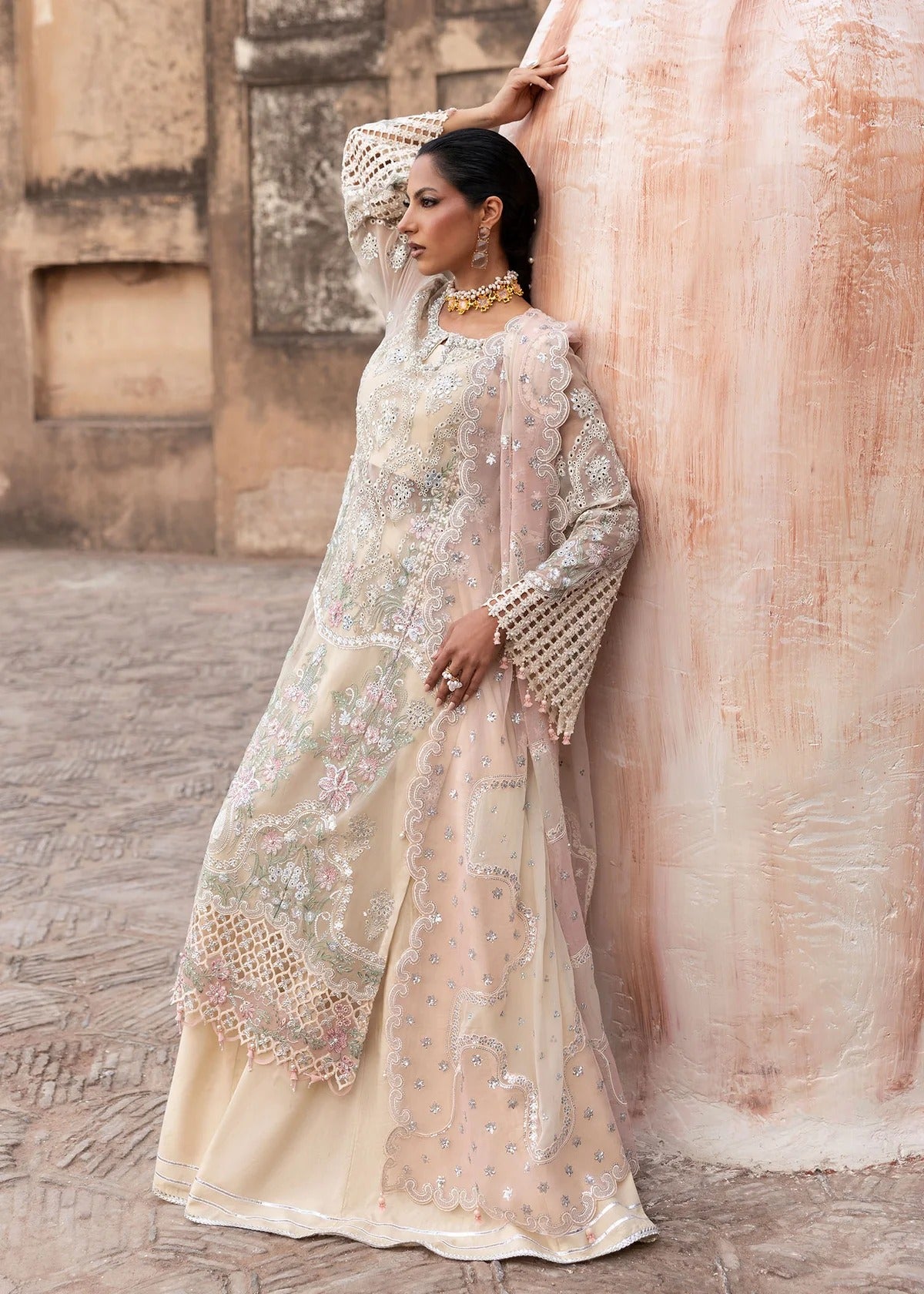 Elegant chiffon embroidered suit with hand embellishment, cutwork borders, diamante & mukesh dupatta, and raw silk trouser perfect for festive wear.