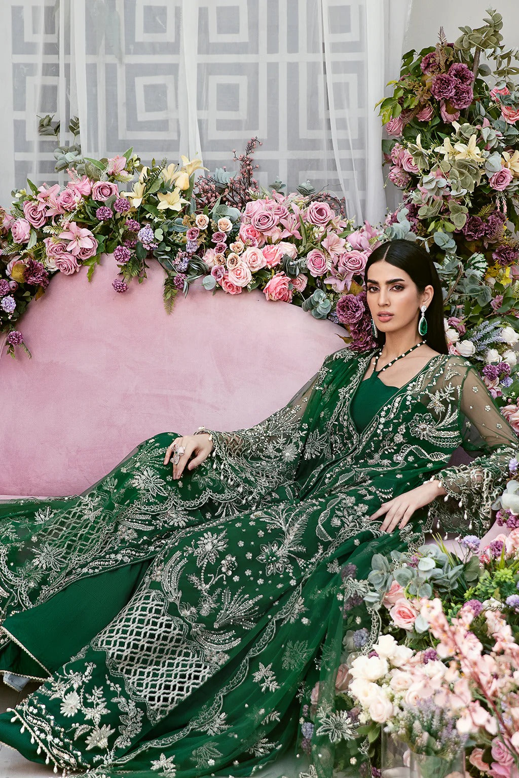 Luxury poly net embroidered suit with hand-embellished panels, cutwork sleeves, organza borders, embroidered dupatta, and raw silk trouser fabric.