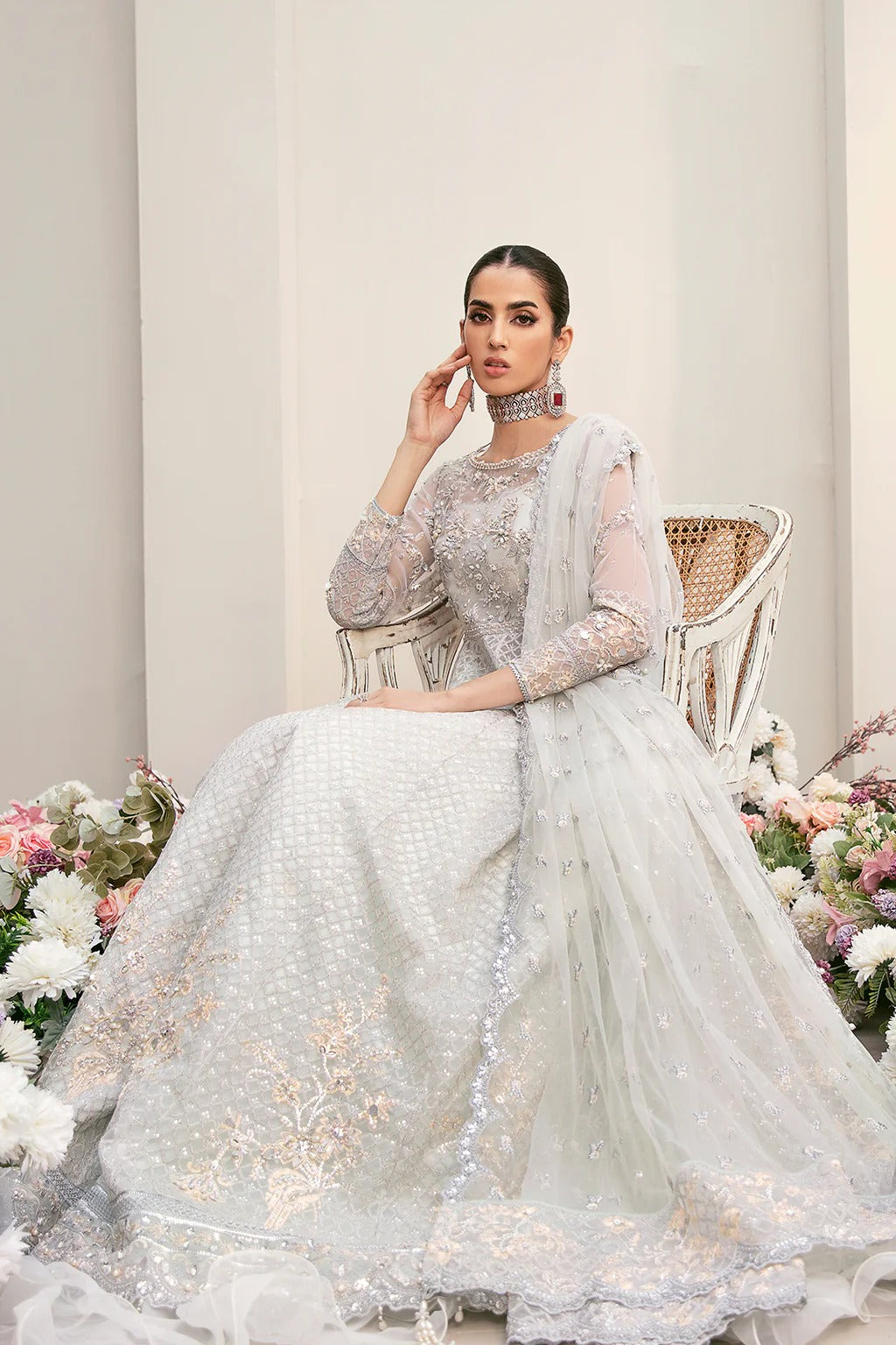 Elegant organza embroidered suit with hand-embellished bodice, cutwork panels, detailed borders, dupatta, and premium raw silk trouser fabric.
