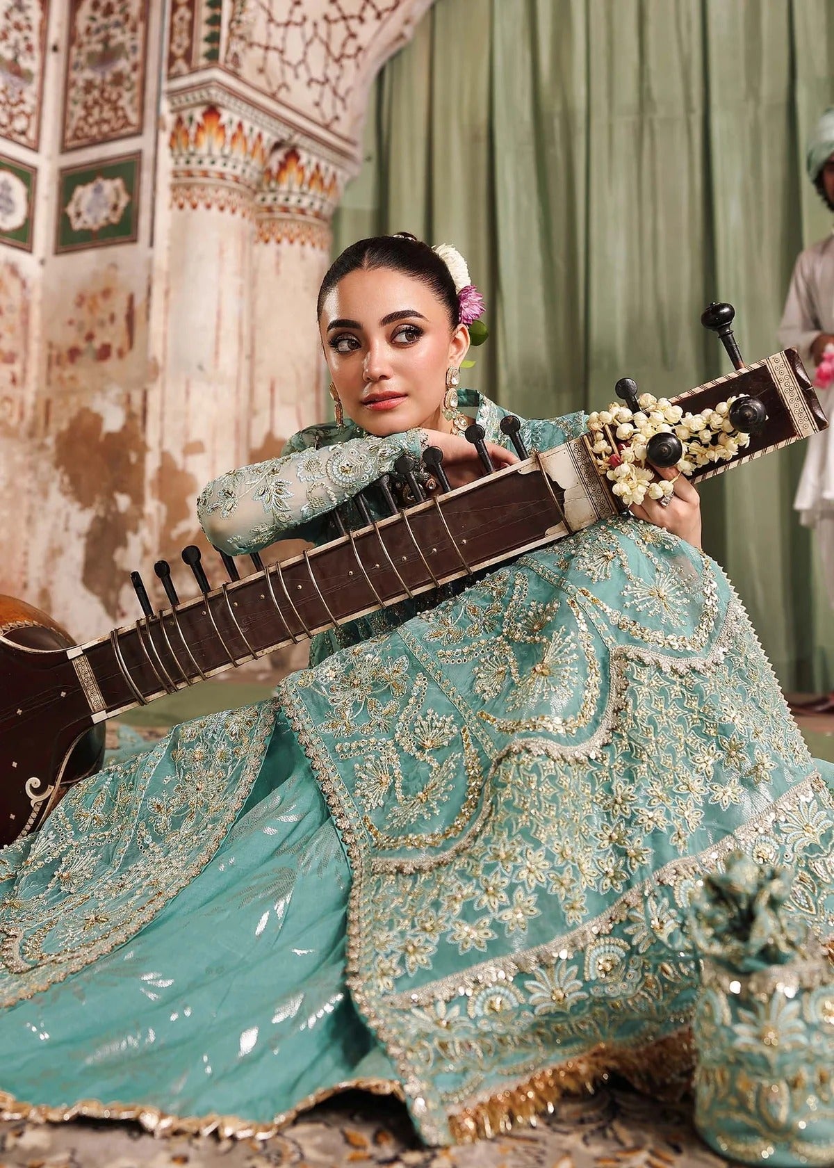 Discover timeless elegance with this turquoise organza outfit featuring intricate hand embroidery, foil-printed raw silk trouser, and embroidered dupatta.