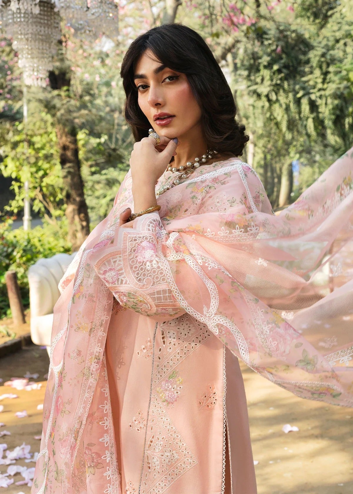 Grace your look with this peach embroidered lawn suit featuring chikan-kari panels, hand-work neckline, net dupatta, and cotton trouser.