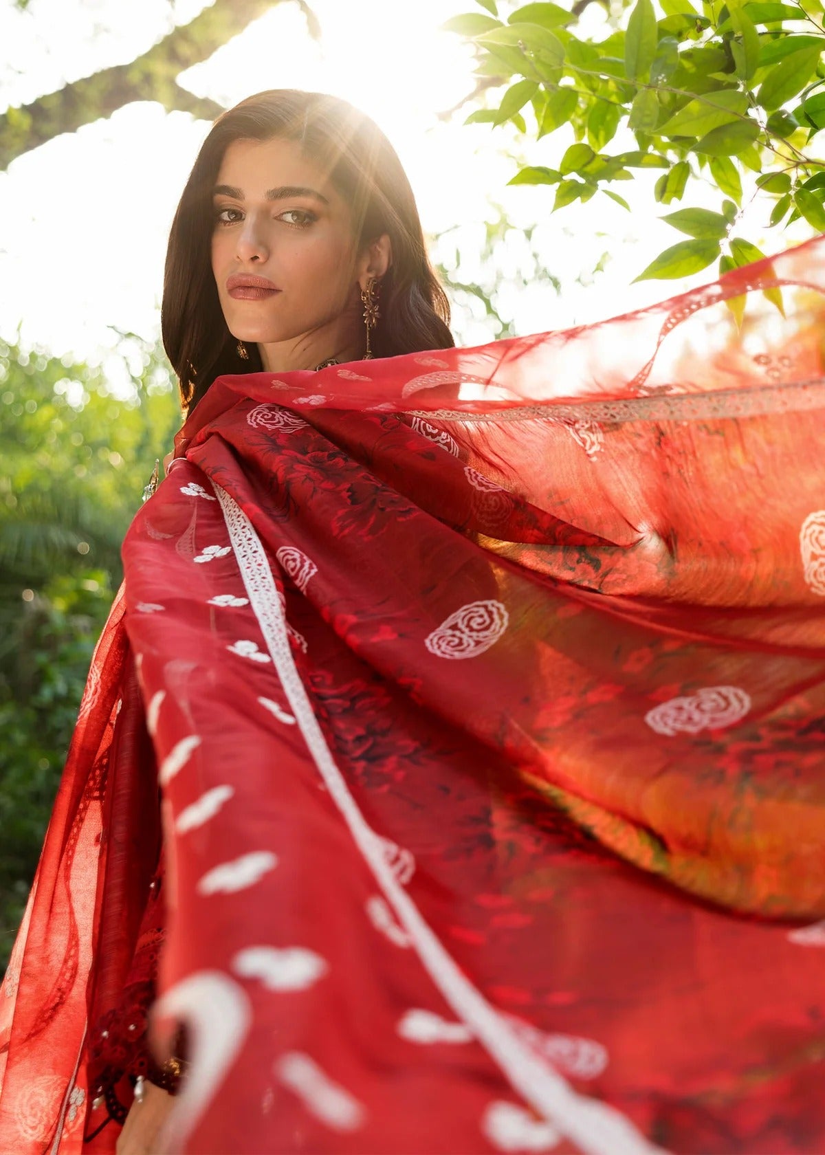 Stun in this maroon embroidered lawn suit with hand-work neckline, chikan-kari panels, 3D flowers, monar dupatta, and cotton trouser.