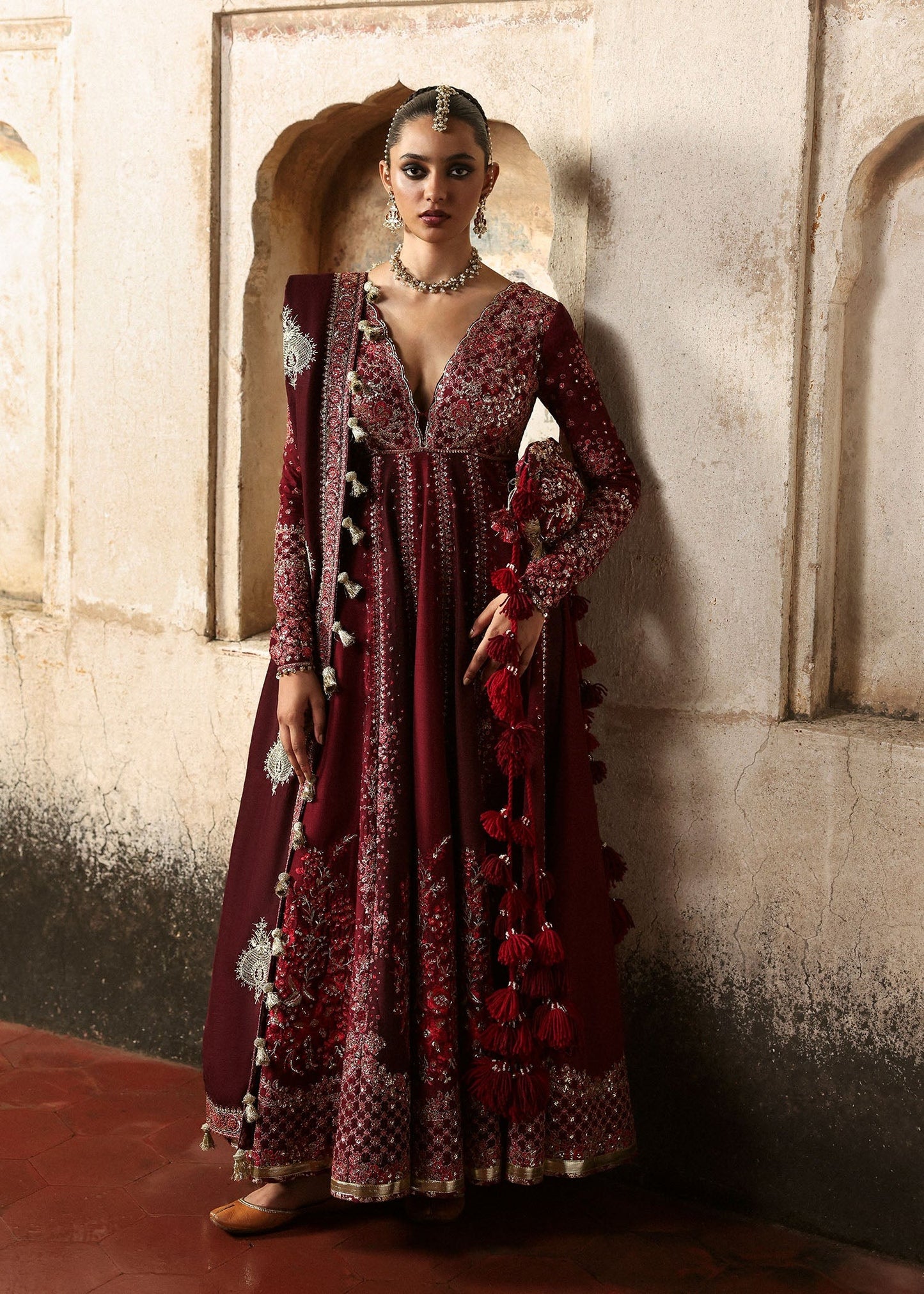 Elegant burgundy and maroon Korean raw silk pishwas with rich embroidery and matching churidar. Unstitched luxury outfit for timeless royal grace.