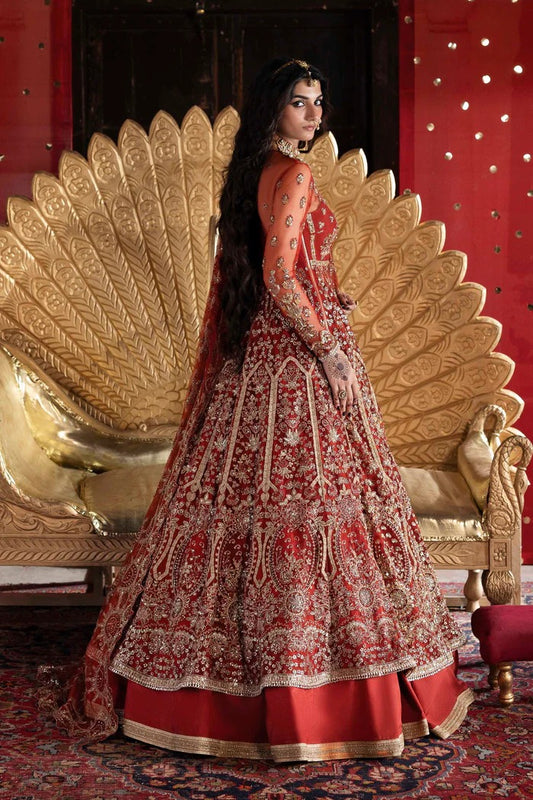 Elegant net dress with hand-embellished panels, blouse, sleeves & dupatta, paired with raw silk inner—crafted for refined beauty and timeless charm.