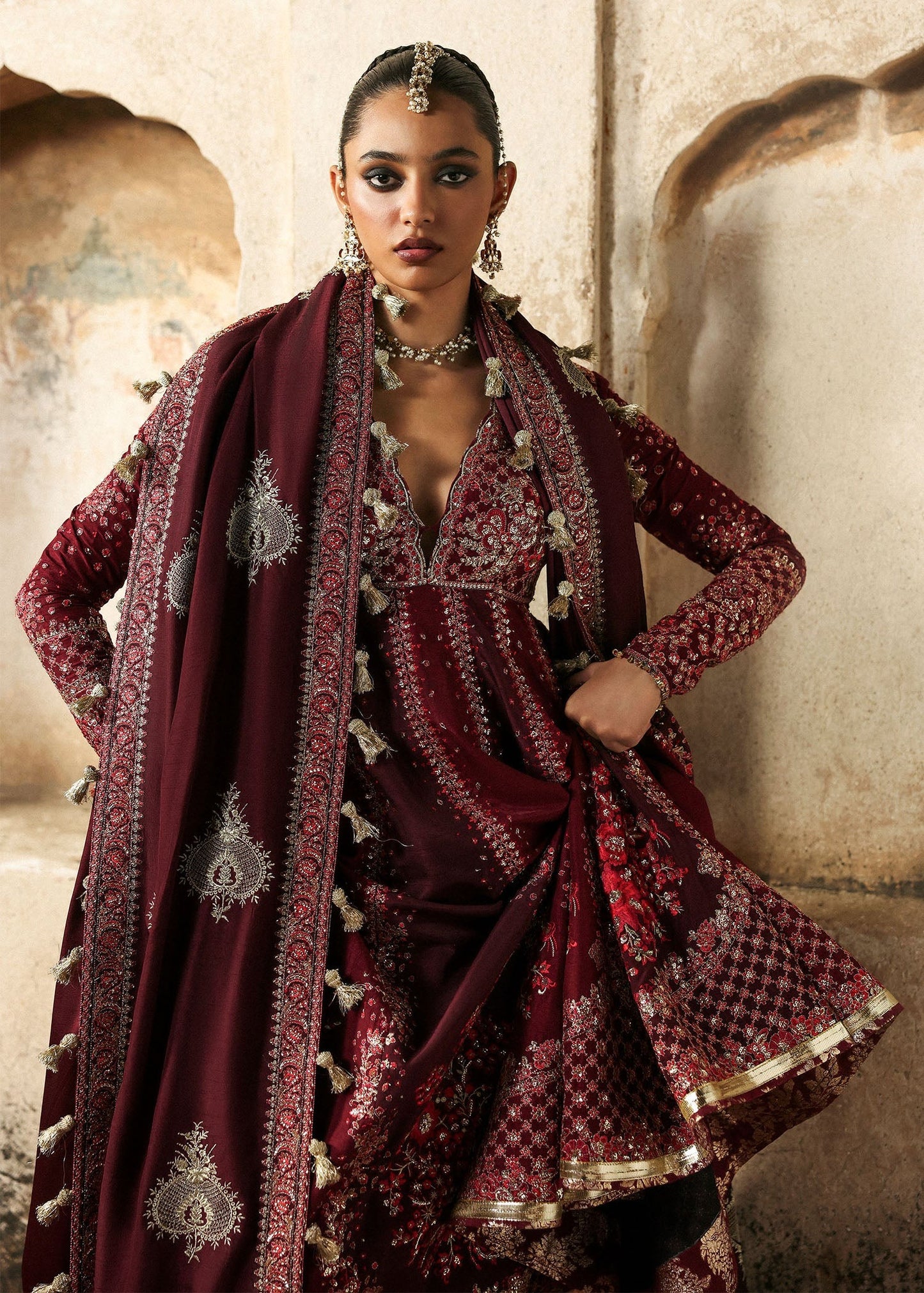 Elegant burgundy and maroon Korean raw silk pishwas with rich embroidery and matching churidar. Unstitched luxury outfit for timeless royal grace.