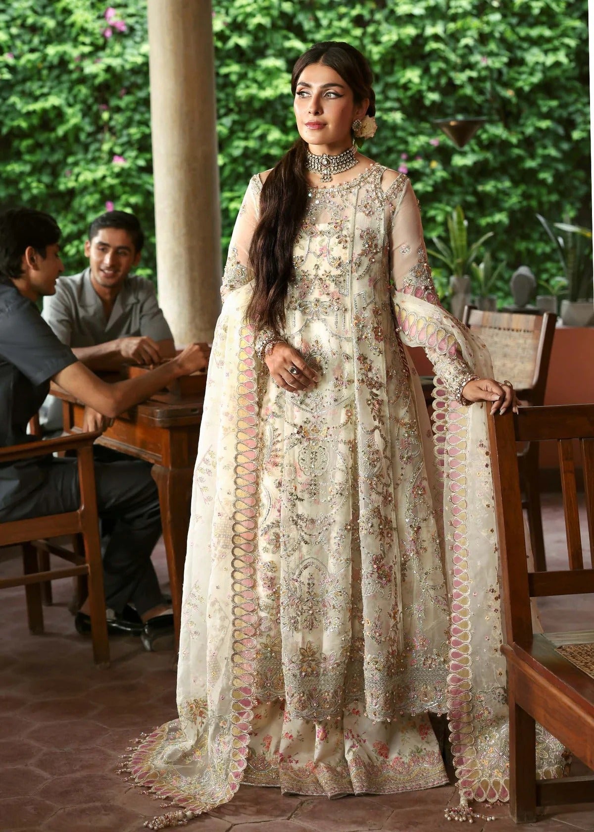 Ethereal ivory frost suit with hand-embellished organza panels, ornate borders, embroidered dupatta, and printed trouser for timeless elegance.