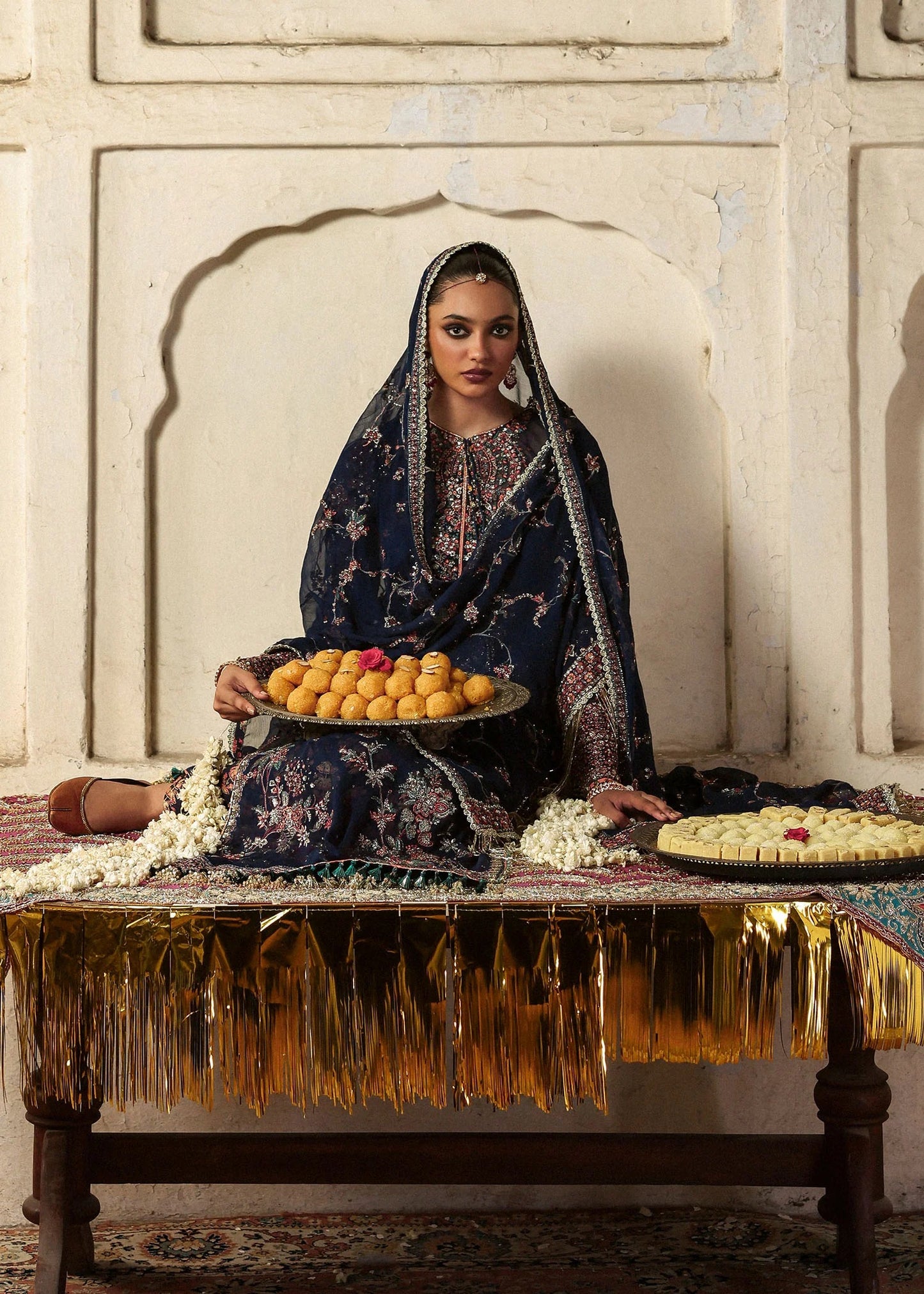 Elegant navy blue chiffon shirt with rich embroidery, silk churidar, and chiffon dupatta. Unstitched festive outfit blending modern grace and timeless charm.