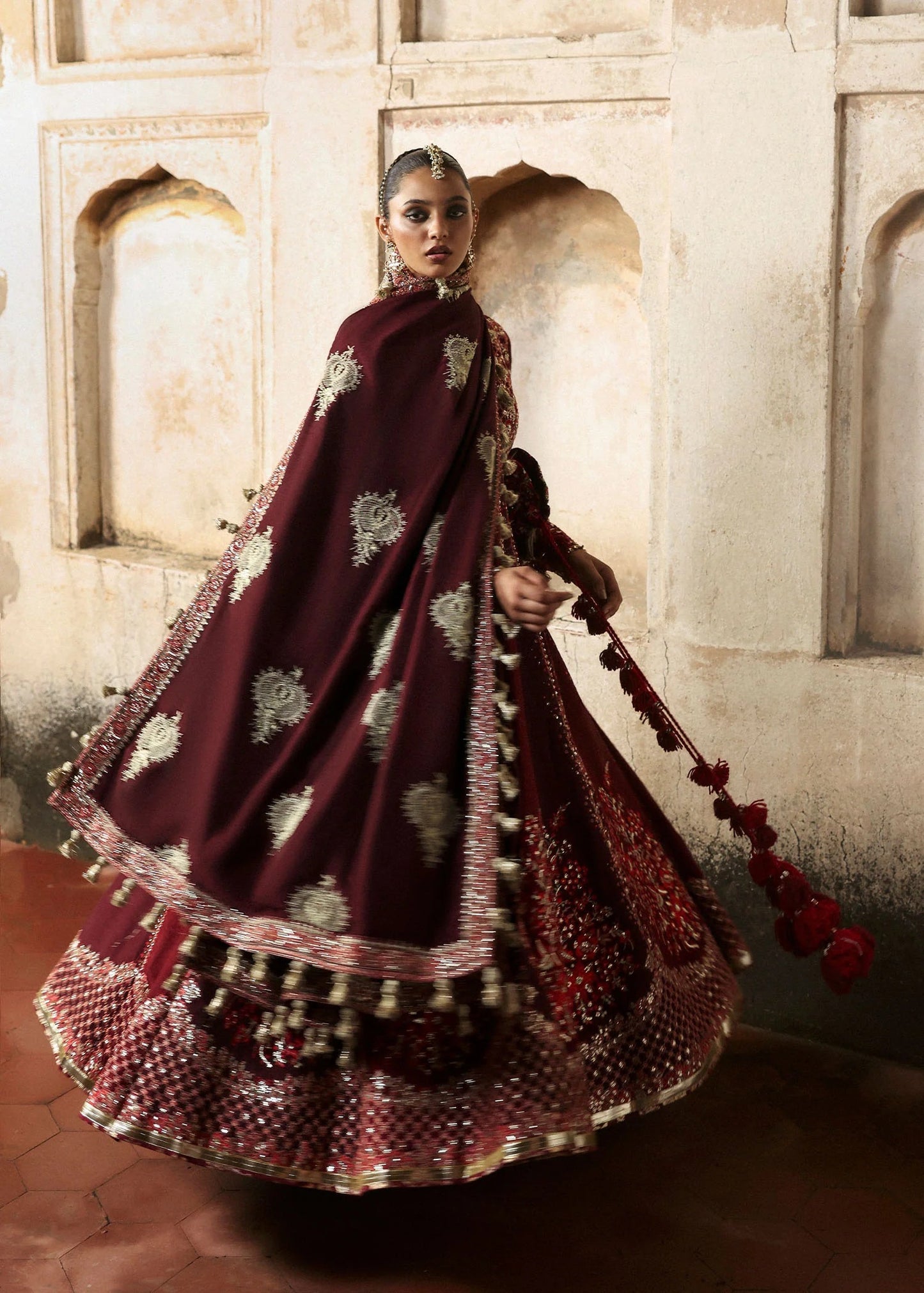 Elegant burgundy and maroon Korean raw silk pishwas with rich embroidery and matching churidar. Unstitched luxury outfit for timeless royal grace.