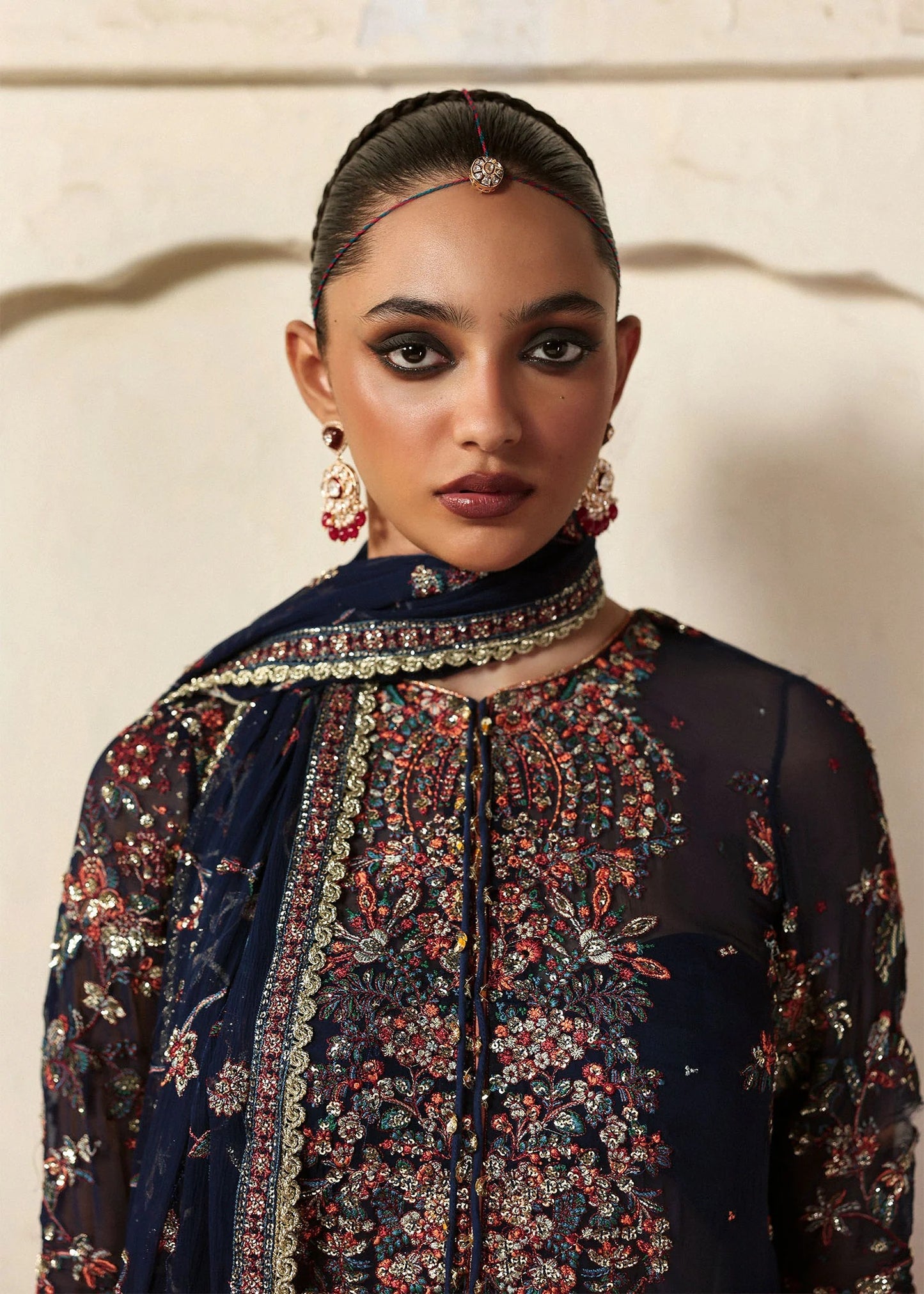 Elegant navy blue chiffon shirt with rich embroidery, silk churidar, and chiffon dupatta. Unstitched festive outfit blending modern grace and timeless charm.