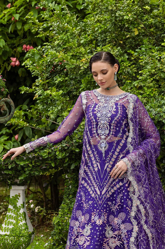 Luxurious purple dress featuring embroidered net shirt, sequined dupatta, raw silk trouser, pearl embellishments, and handmade tassels.