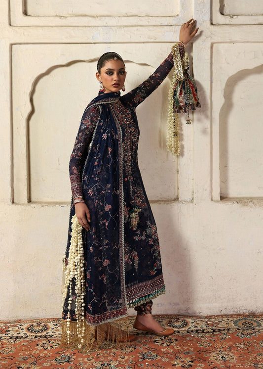 Elegant navy blue chiffon shirt with rich embroidery, silk churidar, and chiffon dupatta. Unstitched festive outfit blending modern grace and timeless charm.