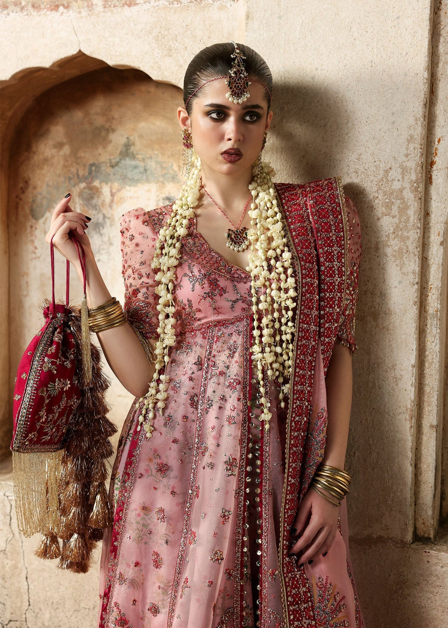 Chic rose pink organza pishwas with embroidered panels, silk lehnga, and chiffon dupatta. Unstitched festive outfit blending elegance with modern charm.