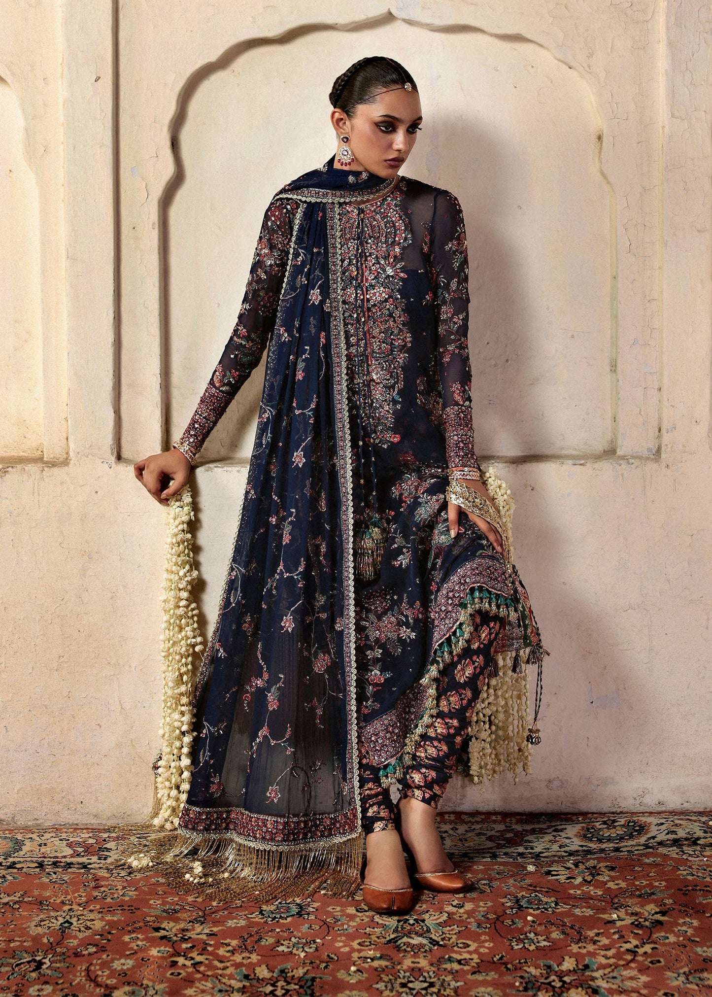 Elegant navy blue chiffon shirt with rich embroidery, silk churidar, and chiffon dupatta. Unstitched festive outfit blending modern grace and timeless charm.