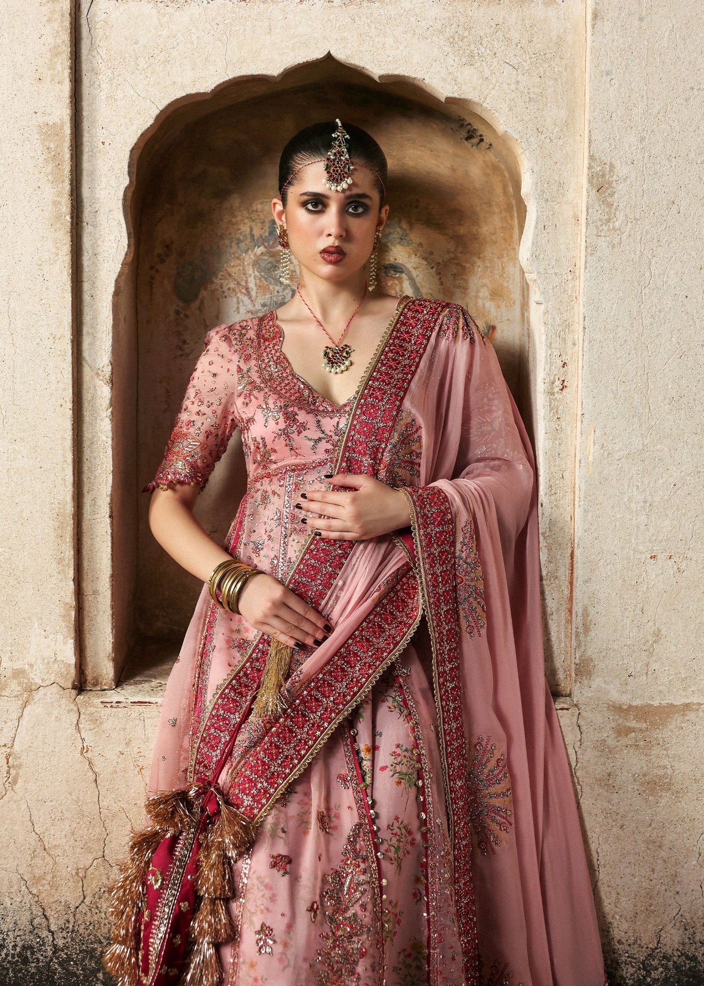 Chic rose pink organza pishwas with embroidered panels, silk lehnga, and chiffon dupatta. Unstitched festive outfit blending elegance with modern charm.