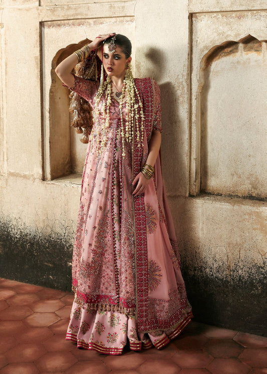 Chic rose pink organza pishwas with embroidered panels, silk lehnga, and chiffon dupatta. Unstitched festive outfit blending elegance with modern charm.