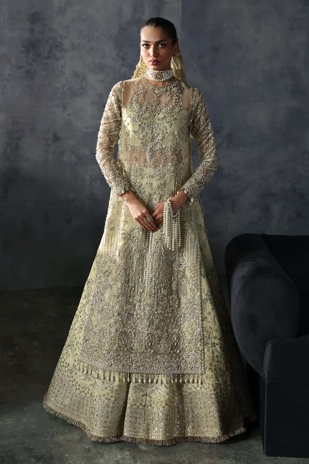Luxurious organza suit with hand-embellished embroidery, ornate dupatta borders, and embroidered raw silk trouser — perfect for festive elegance.