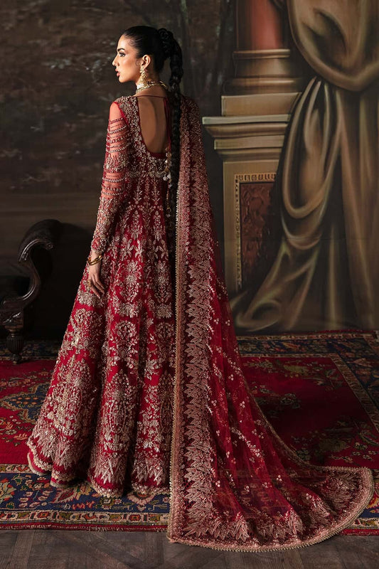 Elegant net suit featuring hand-embellished panels, organza borders, embroidered dupatta, and raw silk trouser — perfect for festive elegance.