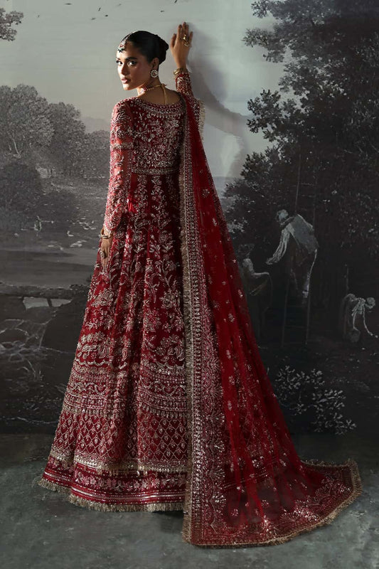 Luxurious net suit with hand-embellished panels, embroidered dupatta with motifs, and raw silk trouser — perfect for weddings and festive wear.