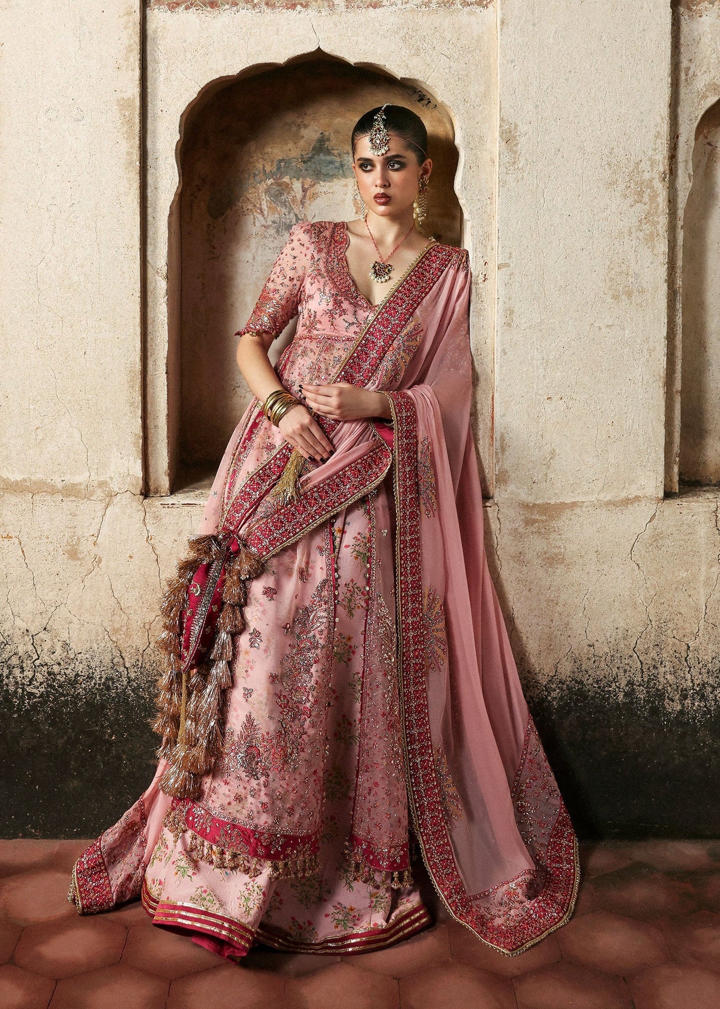 Chic rose pink organza pishwas with embroidered panels, silk lehnga, and chiffon dupatta. Unstitched festive outfit blending elegance with modern charm.
