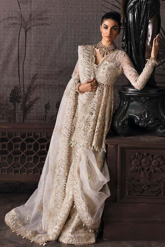 Luxurious organza suit featuring hand-embellished panels, embroidered dupatta, and raw silk trouser — perfect for festive and formal occasions.
