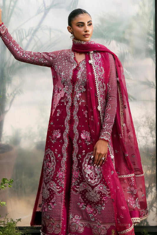 Elegant soft pink organza suit with embroidered panels, red accents, silk dupatta borders, and matching raw silk trouser for a refined look.