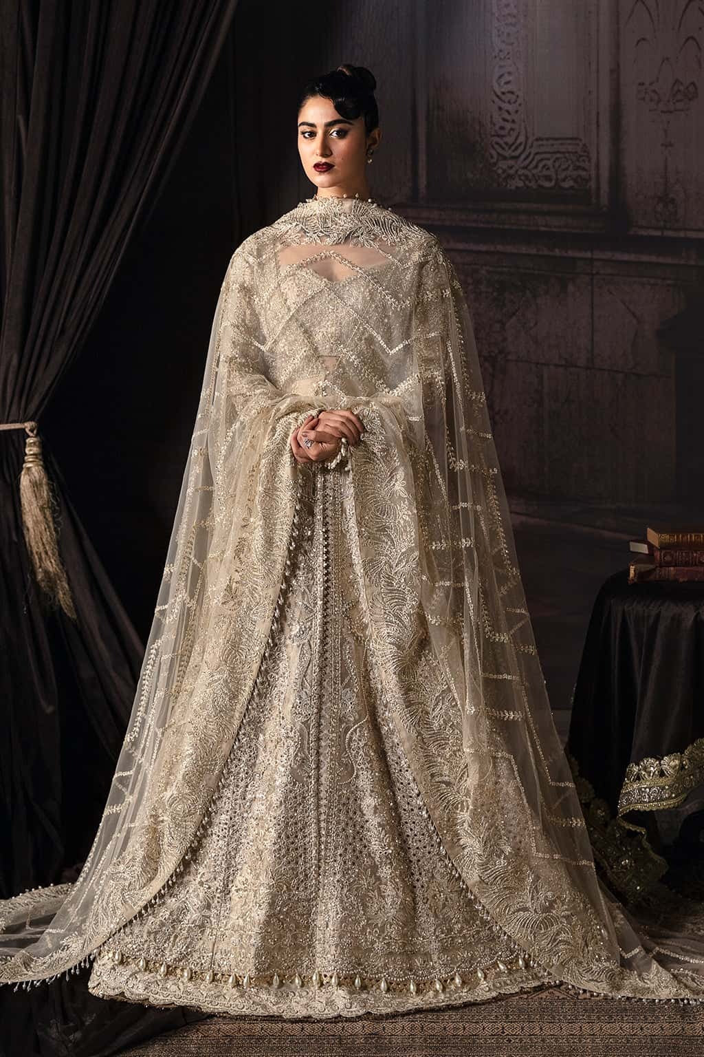 Elegant zari suit featuring hand-embellished panels, embroidered dupatta with borders, and jamavar trouser — perfect for festive and bridal wear.
